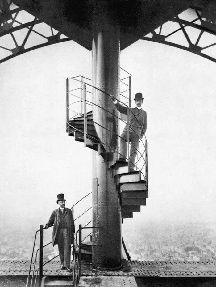 Alexandre Gustave Eiffel, left, explores the completed tower with a friend, 1889. - Rare Vintage Photos
