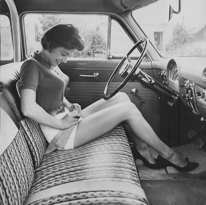 Woman inspecting this new thing, the security belt in her car, circa 1950s. - Rare Vintage Photos