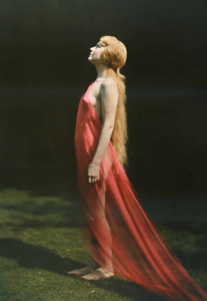 A woman draped in red silk looks by Franklin Price Knott - Most Iconic Photos From the National Geographic Archives