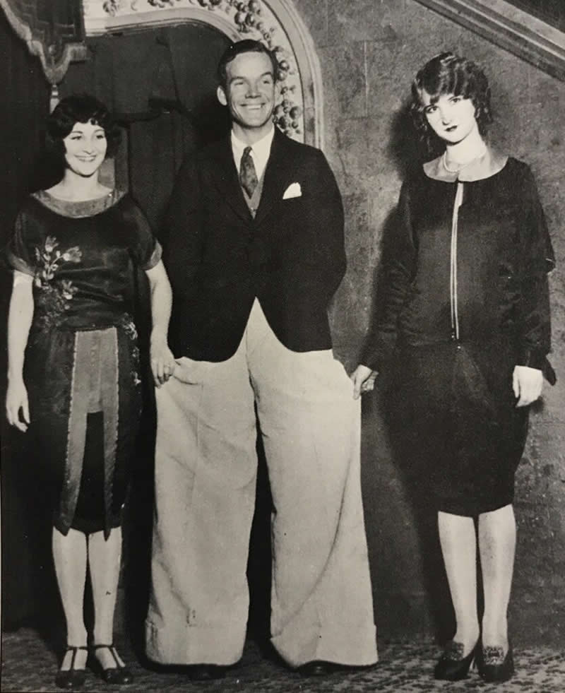 A young man in Los Angeles proudly shows off his flappy white “Oxford bags”, circa 1920s.