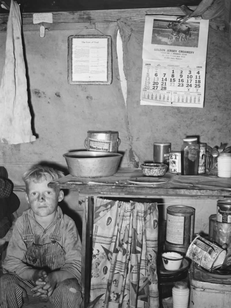 Laborer's child sits by the kitchen cabinet in a tent home, Edinburg, Texas, 1939.