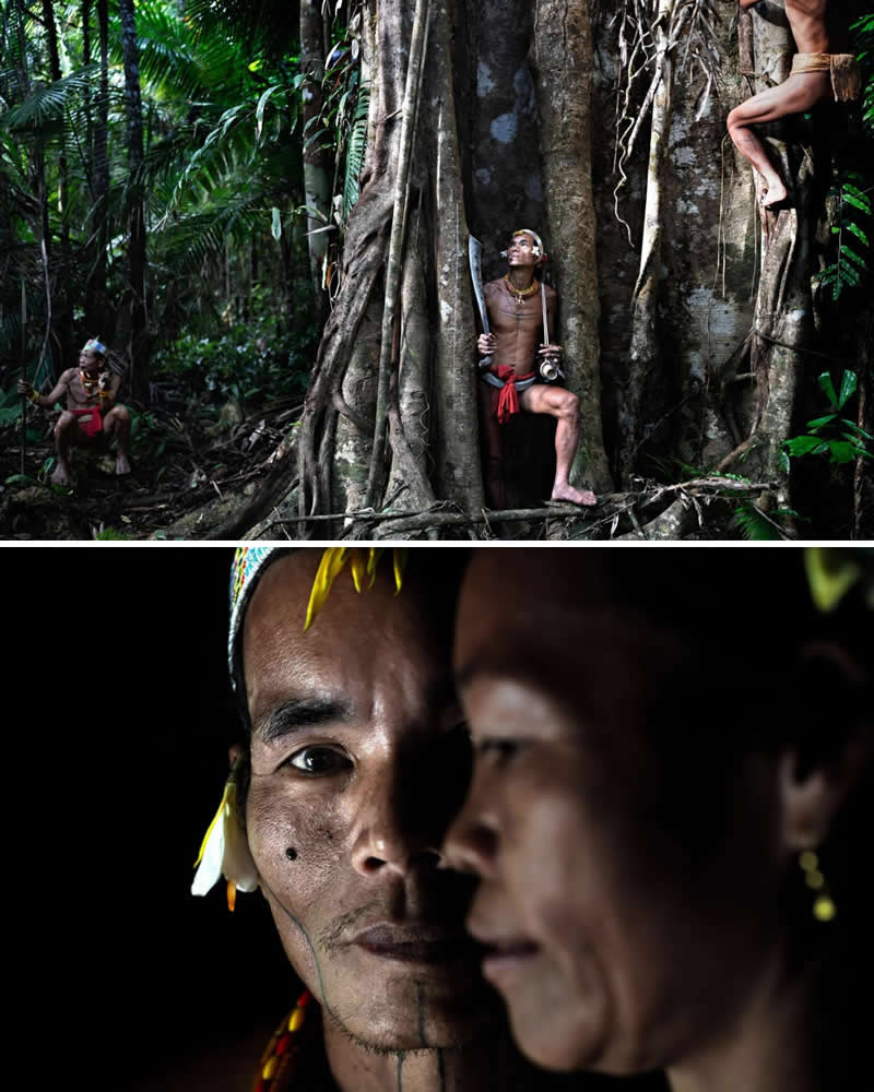 A Mentawai Sikerei shaman stands with fellow villagers in Indonesia’s lush rainforest, surrounded by towering jungle trees. The image captures the close spiritual and cultural bond the Mentawai people share with their forest, reflecting their deep connection to the land and its traditions.