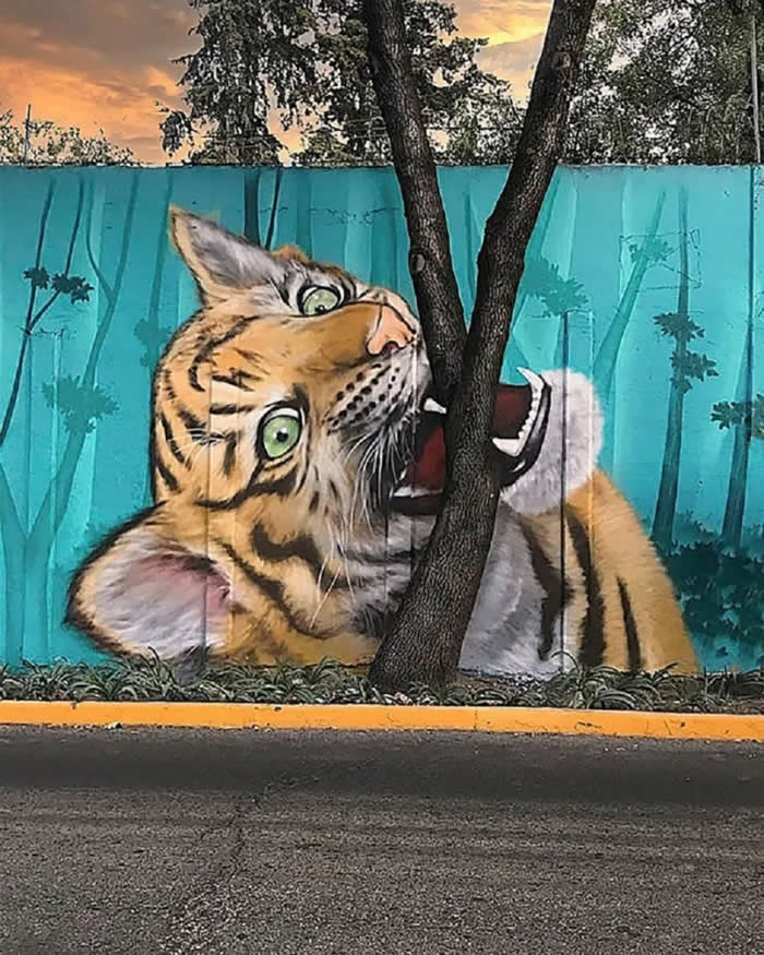 Tiger Bites a Tree — By Koka Mexico in Mexico City, Mexico - Clever Street Art Photos