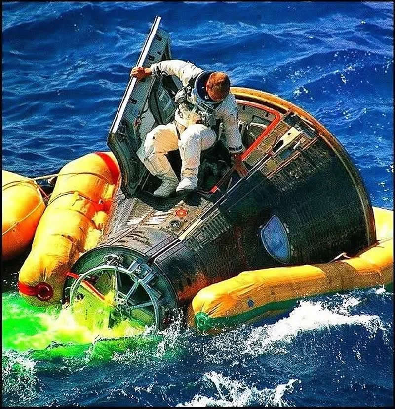 Pete Conrad emerges from the Command Module following splashdown of Gemini 11 in the Atlantic Ocean, Sept 1966
