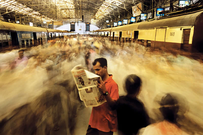 Overcorwded Local Trains Connecting Mumbai with its Suburbs, Mumbai, India by Raghu Rai - Iconic Color Photos by Legendary Photographers