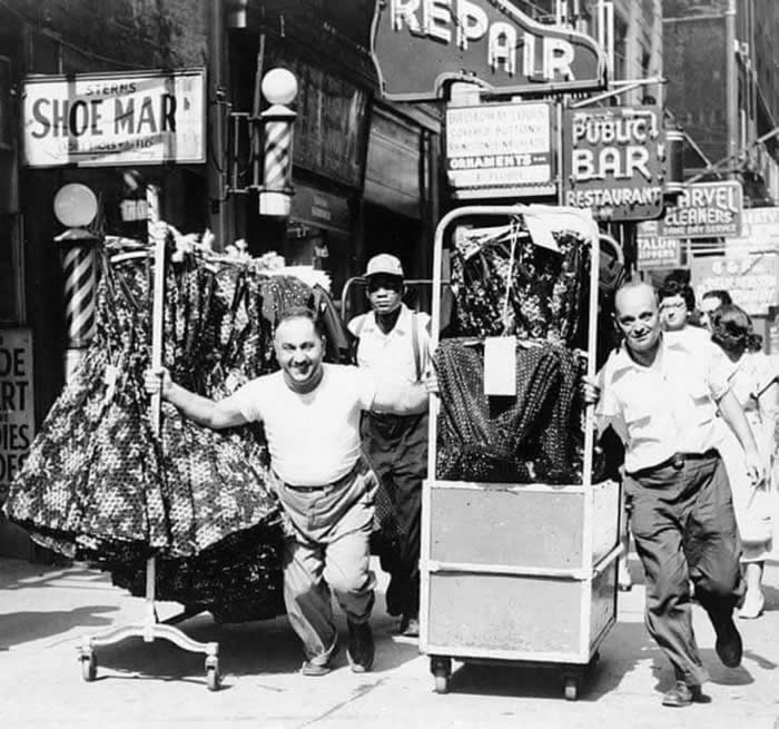 Old New York Revealed: 35 Rare Historical Photos That Capture Forgotten Moments 59 Men Pulling racks of clothing on a busy sidewalk in the Garment District, 1955.