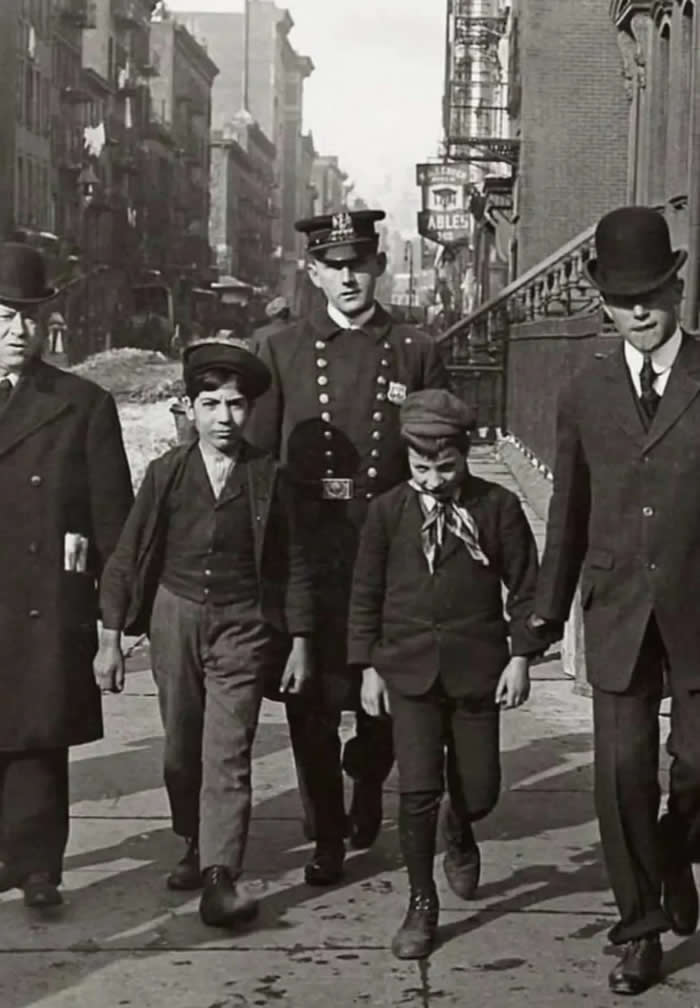 Old New York Revealed: 35 Rare Historical Photos That Capture Forgotten Moments 72 Two young boys are being arrested for pickpocketing on a bustling street in New York City. The boys were caught operating as a pickpocketing duo in Manhattan. Early 20th century.