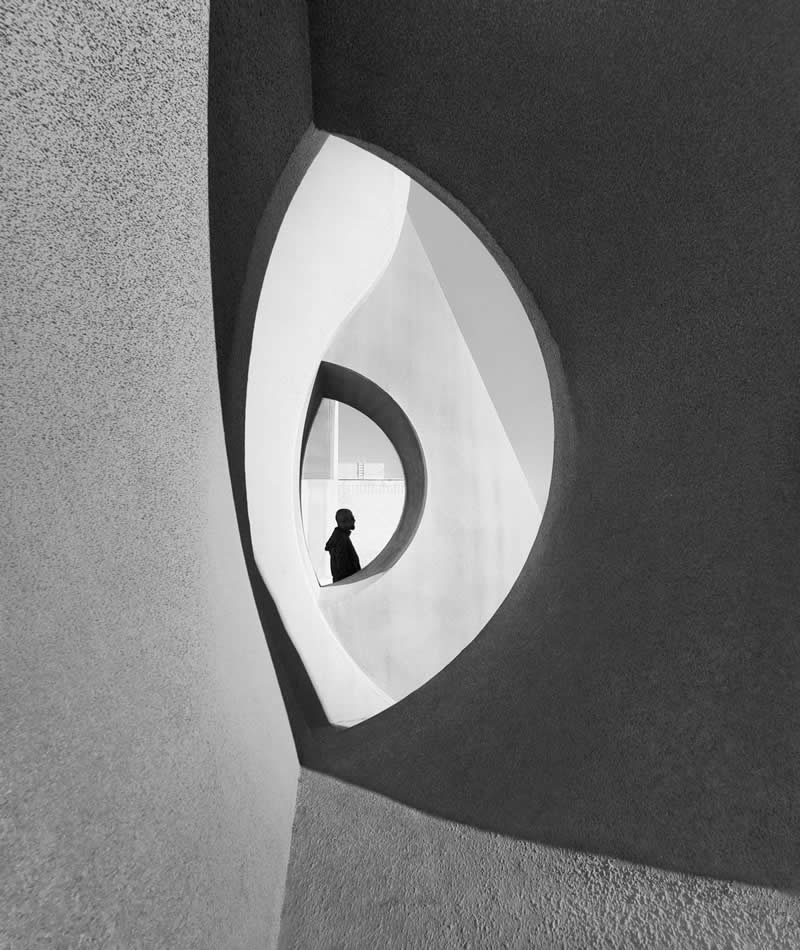 The Mobile Revolution: What the Winners of 35AWARDS Tell Us About the Future of Phone Cameras 47 A silhouetted person stands within a circular opening framed by larger curved architectural shapes in a black-and-white scene. Smooth textures, flowing lines, and strong contrast create a minimalist composition emphasizing depth, symmetry, and the relationship between space and scale.