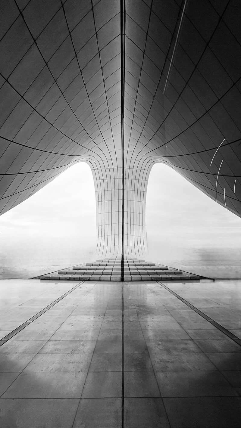 The Mobile Revolution: What the Winners of 35AWARDS Tell Us About the Future of Phone Cameras 48 A black-and-white architectural scene viewed from a perfectly centered perspective. Smooth curved surfaces and geometric lines converge toward a central structure, creating striking symmetry, depth, and scale. The minimalist composition emphasizes form, balance, and the beauty of contemporary architecture.