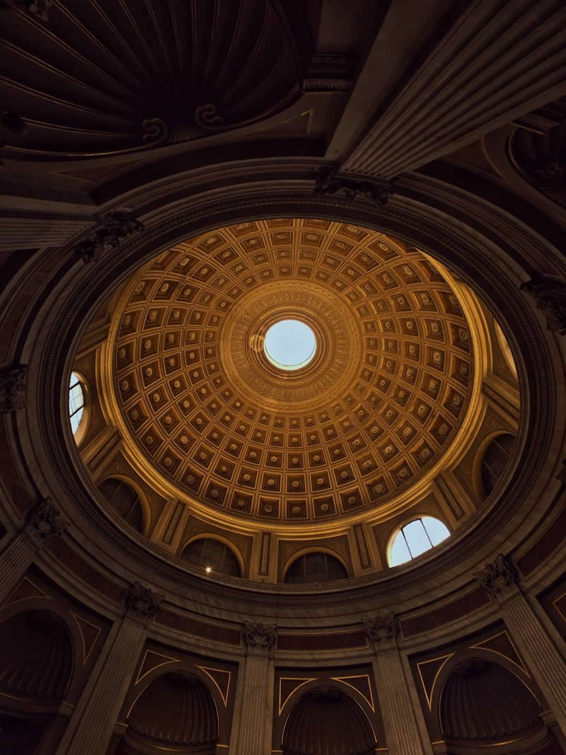 The Mobile Revolution: What the Winners of 35AWARDS Tell Us About the Future of Phone Cameras 52 An upward view of a grand domed ceiling inside a historic building, featuring intricate geometric patterns, decorative arches, and classical columns. Warm golden light highlights the architectural details, while a circular skylight at the center creates symmetry, depth, and visual balance.