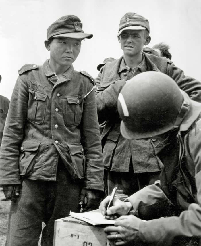 The Past Unfiltered: 36 Rare Historical Photos That Reveal the Human Side of History 60 A soldier registers prisoners of war on June 7, 1944, at Utah Beach (France). Among them is Yang Jong-Kyoung, a Korean born in 1920. He enlisted in the Japanese Kwantung Army in 1938, was captured by the Soviet army at Nomohan and then recaptured by the Germans at the Battle of Kharkov in 1943.