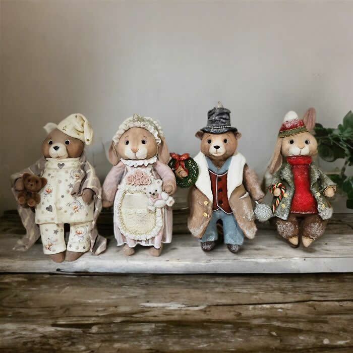 Miniature World: 33 Cotton Wool Sculptures by Katya Celebrating the Magic of Handmade Craft 58 A group of handcrafted miniature cotton wool animal ornaments stands together on a tray, including bears and rabbits dressed in cozy winter clothing and vintage-inspired holiday outfits, each with its own charming personality and handmade details.