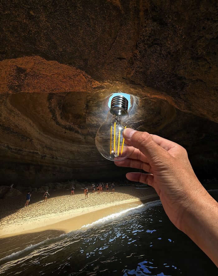 Pure Visual Magic: 35 Mind-Bending Forced Perspective Photos by Hugo Suíssas 39 A hand holds a clear light bulb in front of a cave opening, aligning it so the bright sunlight pouring into the sea cave looks like the bulb is glowing above a sandy beach and small people below.