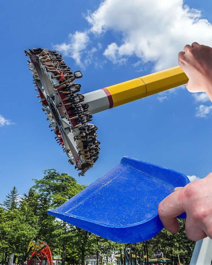Pure Visual Magic: 35 Mind-Bending Forced Perspective Photos by Hugo Suíssas 59 A hand holds a yellow broom handle and a blue dustpan in the foreground, aligned with a spinning amusement park ride so the ride appears to be swept up like debris in a clever forced perspective illusion.