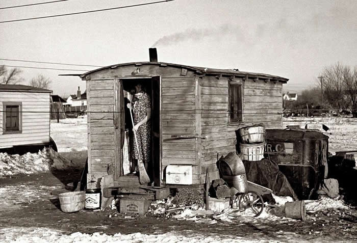The Past Unfiltered: 34 Rare Historical Photos That Reveal the Human Side of History 41 Mrs. Charles Binning sweeping the steps of her shack in Shantytown, Spencer, Iowa during the Depression. 1936.